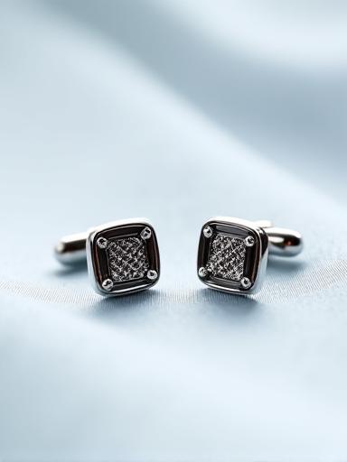 A pair of elegantly designed sterling silver cufflinks with a subtle geometric pattern, ready for formal wear.